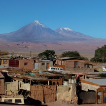 The suburbs of San Pedro de Atacama with the Volcanoes Licancabur and Juriques